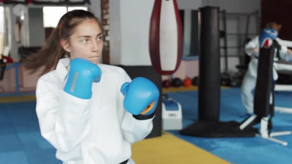 Female Fighters Training with Punching Bags