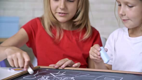 Cute Girls Drawing with Chalk Together alt
