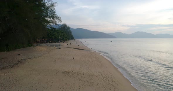 A fasting drone shot over the Batu Feringghi beach in Penang, Malaysia.