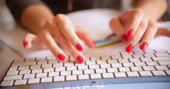Female Hands are Typing on Keyboard alt