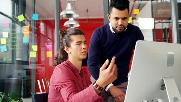 Business executives working on computer at desk