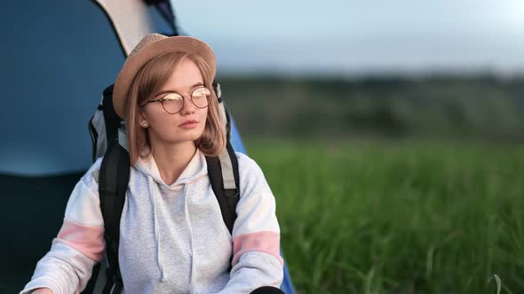 Portrait of Trendy Girl Posing Near Camping Tent After Hiking
