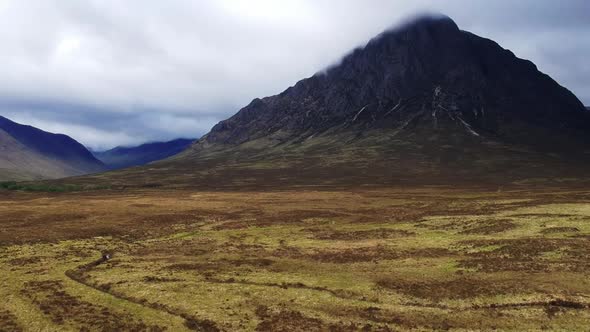 Tilt-down drone shot of scottish highland mountain valley landscape. Aerial video shot by a drone in