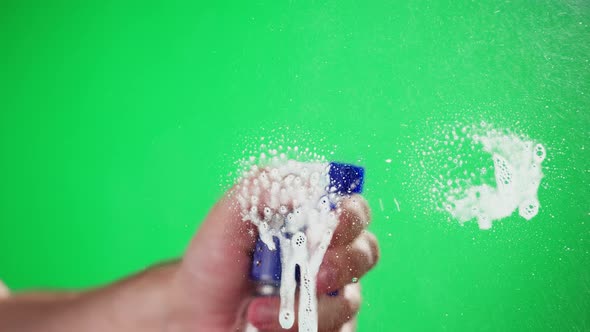 Cleaning Glass Using Spray Detergent on Green Chroma Key Background