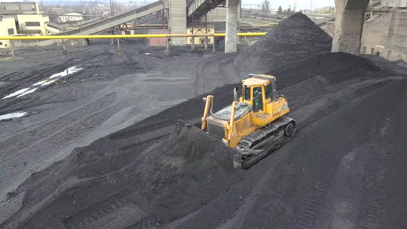 Bulldozer Tractor Collecting Black Coal on Supply Field of Thermoelectric Power Station