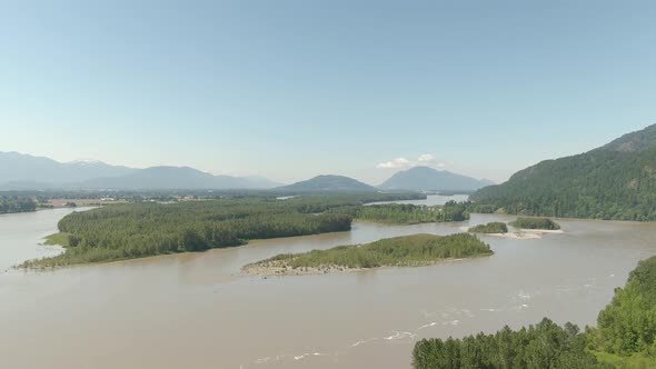 Aerial View of a River in the Valley Surrounded By Canadian Mountain Landscape
