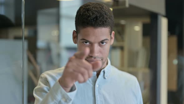 Young African Man Pointing Finger on Camera