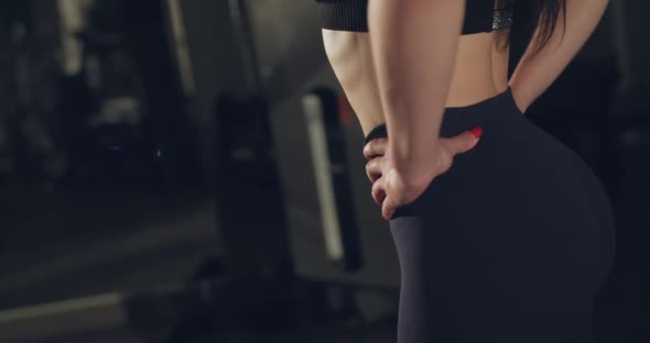 Middle View of Pretty Female Sports Body During Warming Up in a Gym