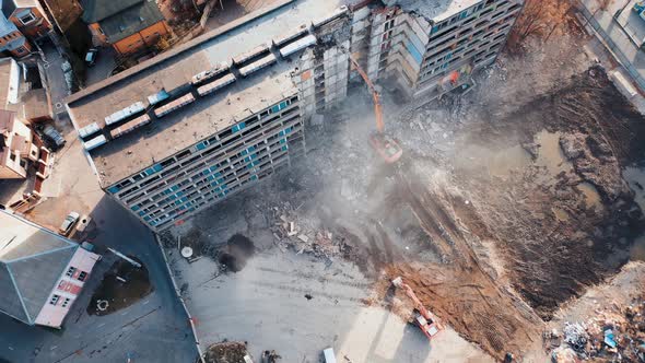 Aerial View Excavators Dismantle The Concrete Structures Of The Building.