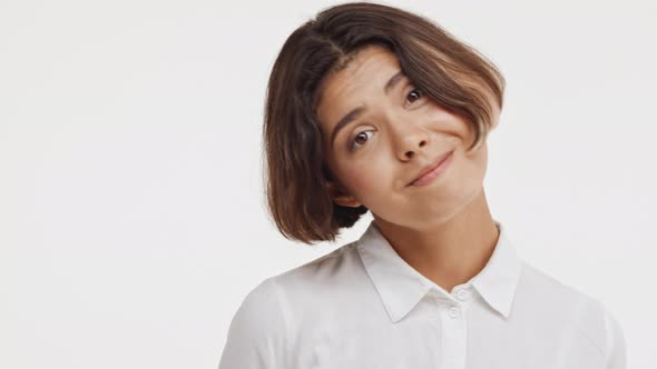 Young Beautiful Brunette East Asian Female in Shirt Looking Childish Shy Coy on White Background