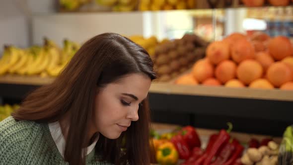 Woman Buyer Choosing Fresh Fruits in Grocery Store