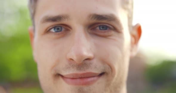 Close Up Face Portrait of Smiling Caucasian Man Outdoors