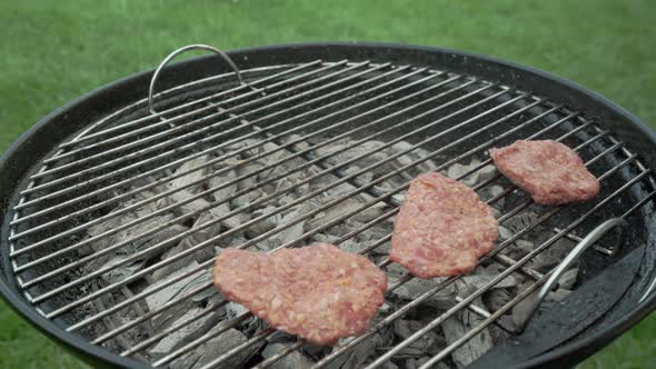 Turkish minced meat also known as meatball or kofte is being cooked on a grill.