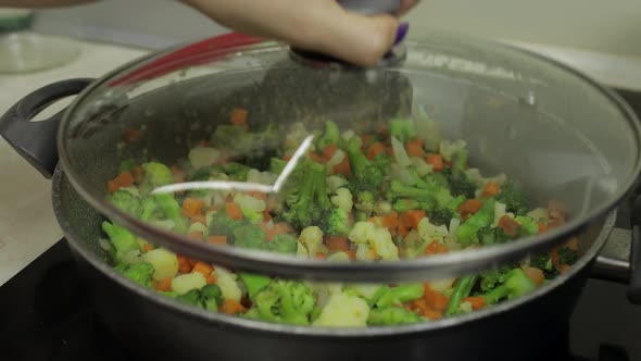 Mixing Fresh Vegetables on Frying Pan. Boiling Carrots, Cauliflower, Broccoli