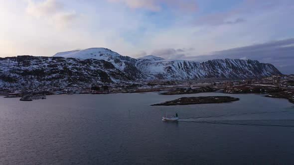 Ship in Fjord and Mountains in Winter. Lofoten Islands, Norway. Aerial View