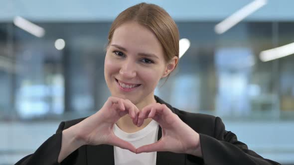 Portrait of Woman Showing Heart Shape By Hands