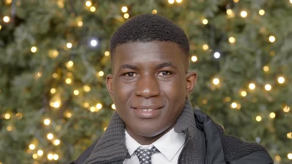 smiling black african businessman in the city at christmas time