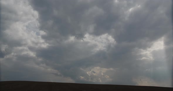 Rain Clouds Through Which The Sun's Rays Pass Timelapse alt