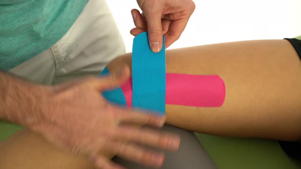 Closeup Pain Relief Taping of Knee