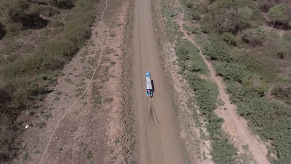 Aerial view of small boat sailing on mud canal, Tonle Sap, Cambodia.