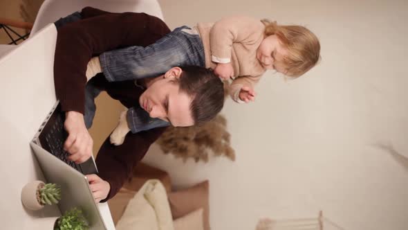 A Man Tries to Work Behind a Laptop at Home