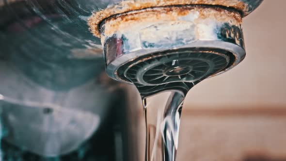 Macro Shot of Faucet with Running Water in Slow Motion