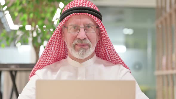 Old Arab Businessman with Laptop Showing Thumbs Up