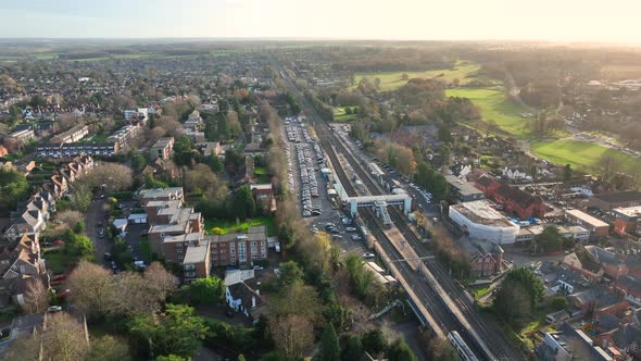 Commuter Train Arriving at a Railway Station in the UK at Sunset