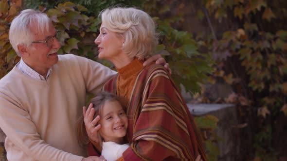 Grandparents enjoying good time with their cute little granddaughter