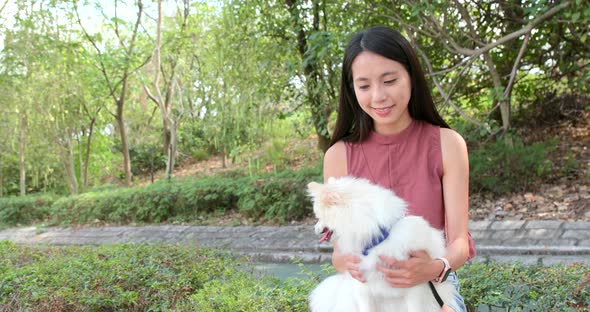 Pomeranian dog with pet owner at outdoor