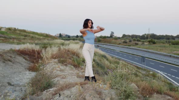 Girl Raises Her Arms To The Sky