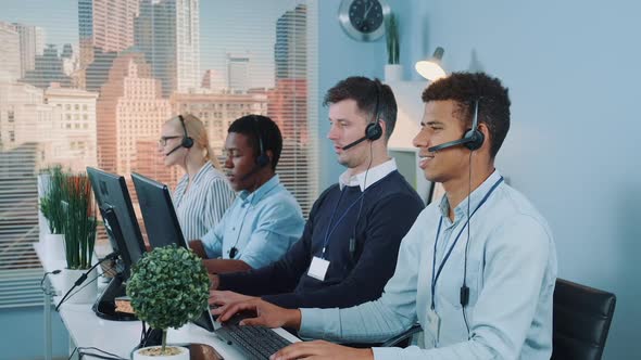 Medium Shot of Diverse Team of Call Center Customers Looking to the Camera and Smiling