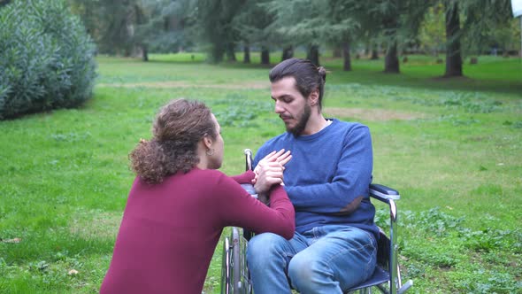 empathy, affection-woman tries to comfort her disabled boyfriend