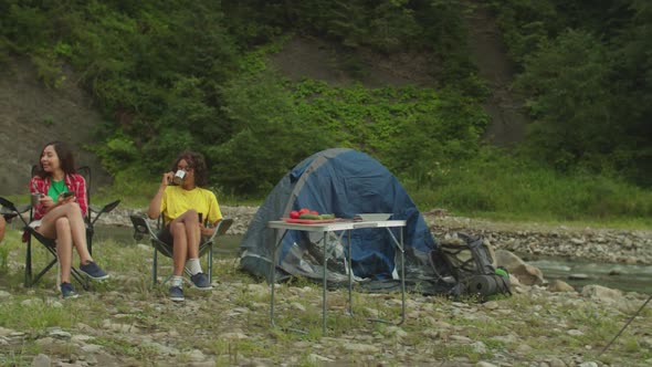 Lovely Cheerful Multiethnic Female Hikers Enjoying Recreation and Freedom at Campsite in Mountains