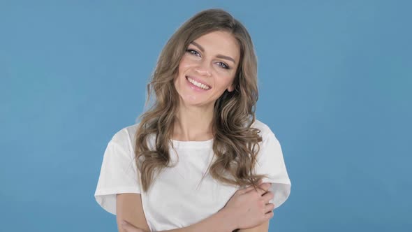 Smiling Young Girl Isolated on Blue Background