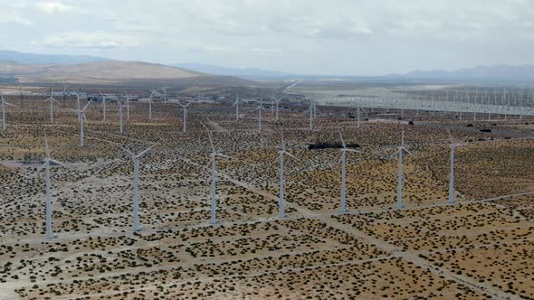 Aerial View of Huge Array of Gigantic Wind Turbines Spreading Over the Desert in Palm Springs.