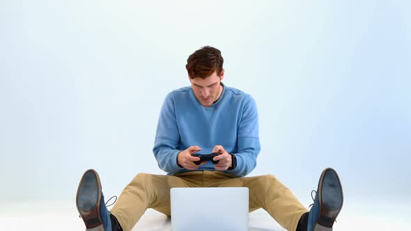 Man playing video game on laptop against white background 4k