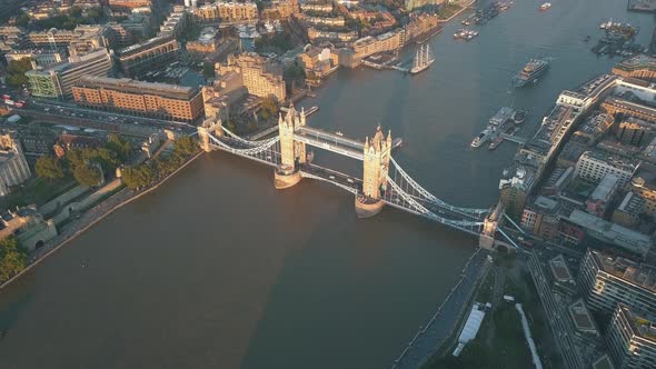 AERIAL: Flying Over Themse Towards Tower Bridge in London at Sunset, Sunrise