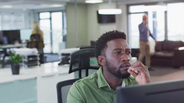 Thoughtful man sitting on his desk at office