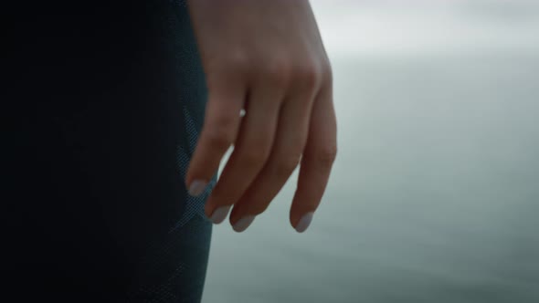 Closeup Hand Girl Standing on Hilltop Sea Beach
