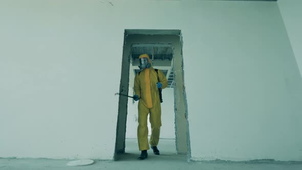 Disinfector Sprays Antiseptics in Unfinished Building.