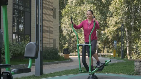 Young Woman Doing Work Out in an Outdoors Gym