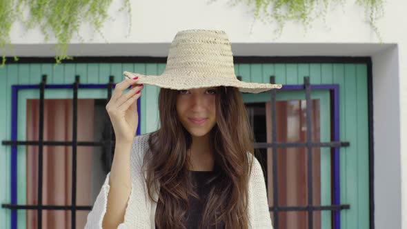 Slow motion shot of young woman wearing straw hat