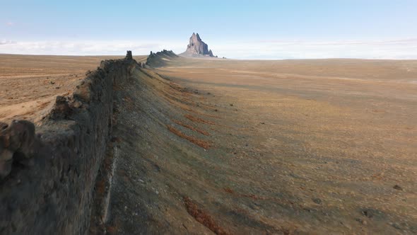 Aerial Footage of Long Rocky Range in the Middle of Barren Landscape Below