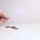 A woman's hand puts coins on the table and counts them. Investment concept. Metallic currency. - VideoHive Item for Sale