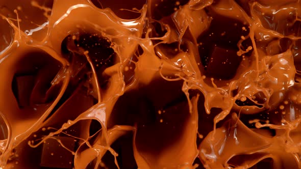 Super Slow Motion Shot of Caramel Chunks Falling Into Melted Caramel at 1000Fps