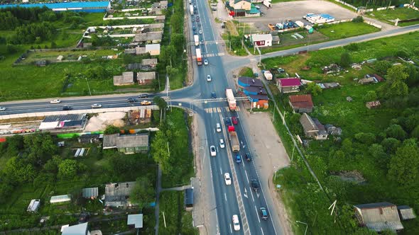 Aerial View of an Asphalt Suburban Intersection with Moving Cars