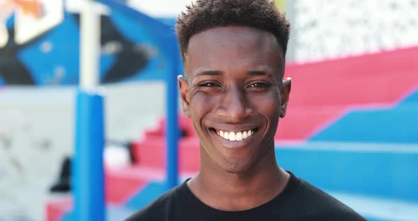 Young african man smiling on camera outdoor