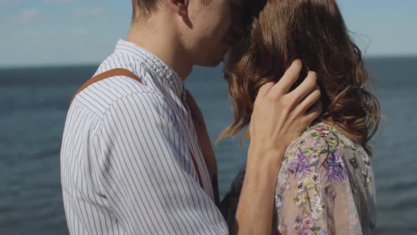 Closeup of Couple in Love Hugs the Couple Stands Opposite Each Other with Their Eyes Closed Slow