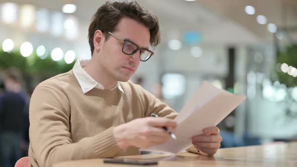 Man Reading Documents in Office